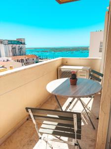 a table and a chair on a balcony at Riamar House - Faro City Center in Faro