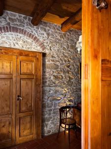 a wooden door in a room with a stone wall at B&B Antico Casale in Fuscaldo +36 photos