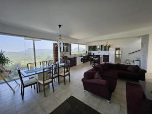 a living room with a couch and a table with chairs at Olive Villa in Episkopianá