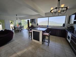 a kitchen and living room with a large window at Olive Villa in Episkopianá