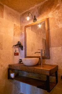 a bathroom with a sink and a mirror at Urgup Evi Cave Hotel in Ürgüp +96 photos
