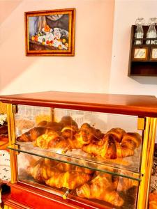 a display case filled with croissants and other pastries at B&B Antico Casale in Fuscaldo
