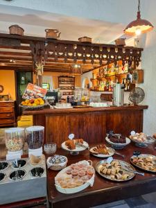a buffet with many plates of food on a table at Vagia Traditional, Aegina Island in Vaia