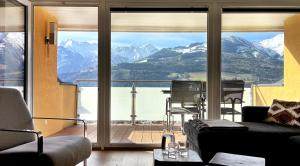 a living room with a view of a mountain at Panoramic Penthouse 10 min to Zell am See & Kaprun in Piesendorf