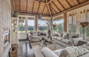 a large living room with couches and a fireplace at 3 Bedroom Cozy Home In Voorthuizen in Voorthuizen