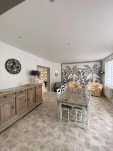 ein Wohnzimmer mit Tisch und Couch in der Unterkunft Chez Valentine in Grand-Fort-Philippe