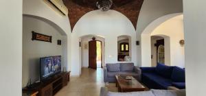 a living room with two couches and a tv at Nayah Stays, Lagoons beach, Paradise 3 ensuite with private pool in El Gouna