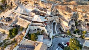 an aerial view of a church with a mountain at Urgup Evi Cave Hotel in Ürgüp