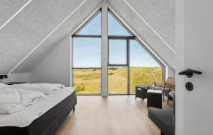 a bedroom with a large window and a bed at 3 Bedroom Nice Home In Skagen in Skagen