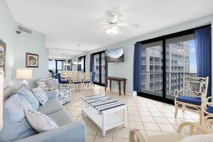 a living room with a couch and a table at Windward Pointe 801- East corner-unit beachfront in Orange Beach