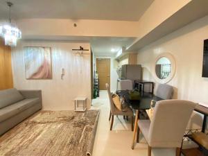 a living room with a couch and a table at Studio Condo near Ayala, Cebu-East Gate in Carreta