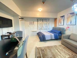 a living room with a bed and a couch at Studio Condo near Ayala, Cebu-East Gate in Carreta