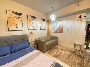 a living room with a bed and a couch at Studio Condo near Ayala, Cebu-East Gate in Carreta