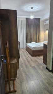 a hotel room with a bed and a bathroom at Guesthouse K2 #1 in Mtskheta