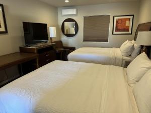 Voodi või voodid majutusasutuse The GQ Extended Stay toas