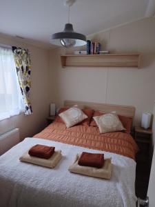 a bedroom with a bed with two pillows on it at Your Holidays in Scotland. in Eyemouth