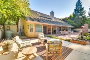 a patio with chairs and a table and a house at 1 Mi to Applegate Park Zoo Pet-Friendly Home in Merced