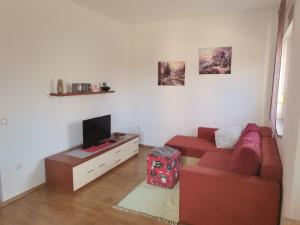 a living room with a red couch and a tv at edwin in Medulin