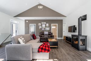 a living room with a couch and a fireplace at Roitelet Private Hot Tub Luxury Escape in Brownsburg