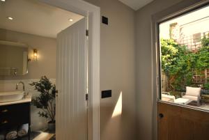 a bathroom with a door leading to a patio at Kittiwake Cottage- stunning coastal cottage in Anstruther +35 photos