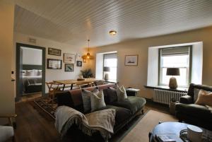 a living room with a couch and a table at Kittiwake Cottage- stunning coastal cottage in Anstruther