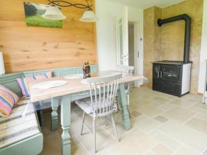 a kitchen with a table and a stove at Entspannung und Erholung, Ferienwohnung mit traumhaftem Blick in die Natur in Oberaurach