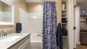 a bathroom with a sink and a shower curtain at Teton Crest Apartment in Driggs +31 photos
