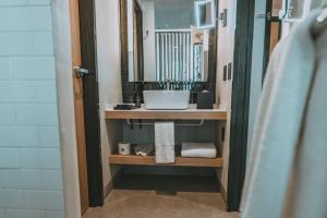 a bathroom with a sink and a mirror at Crowne Plaza Merida by IHG in Mérida