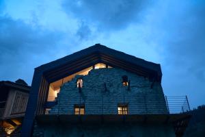 a building with a tower on top of it at night at Heritage Carrel in Valtournenche