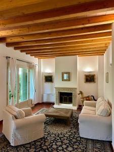 a living room with two couches and a fireplace at Casa Sunset Hill Bologna in Bologna
