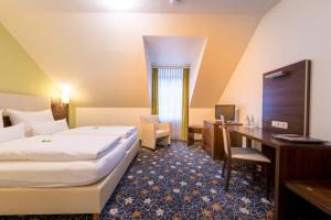 Postel nebo postele na pokoji v ubytování Hotel Bachmühle
