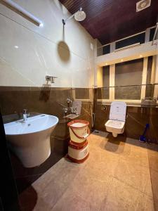 a bathroom with a sink and a toilet at #1BHK Studio Apartment with 3-4 person occupancy Family only in Mangalore