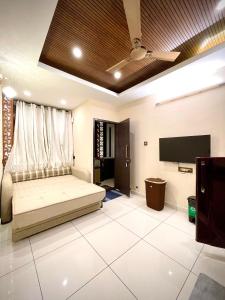 a bedroom with a bed and a flat screen tv at #1BHK Studio Apartment with 3-4 person occupancy Family only in Mangalore +11 photos