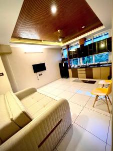 a living room with a couch and a tv at #1BHK Studio Apartment with 3-4 person occupancy Family only in Mangalore
