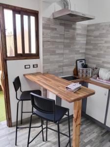 a kitchen with a wooden table and two chairs at Hornera Loft con Terraza in La Laguna