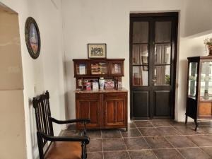 a room with a wooden cabinet and a door at Samsara Hotel Salta in Salta