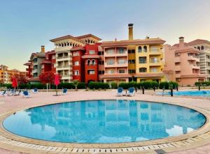 a large swimming pool in front of some buildings at Porto Sharm Chalet for Rent in Sharm El Sheikh