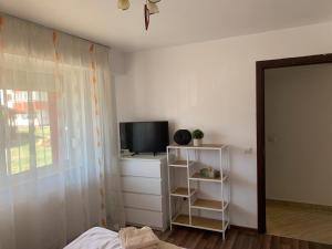 a bedroom with a bed and a television on a dresser at Apartament de lux cu 3 camere in Bacău