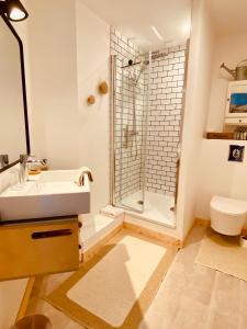 a bathroom with a sink and a shower at La Grange Neuve in Plougonvelin +35 photos