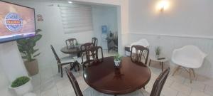 een eetkamer met een tafel en stoelen en een scherm bij HOTEL 507 INN in Mejillones
