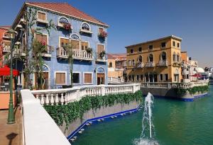 a building with a fountain in the middle of a river at Luxury apartment in Boulevard Hittin in Riyadh