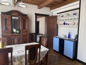 a kitchen with a table and a dining room at More Holiday Cottage L in Bigauņciems