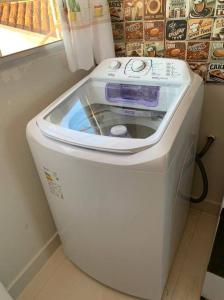 a washer and dryer sitting in a room at kitnet208 No centro,c linda vista , tv smart e ar in Montes Claros
