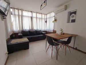 a living room with a couch and a table at Plaza Mayor CENTRO Plaza independencia in Mendoza +9 photos