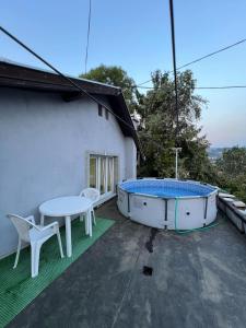 a hot tub and a table on a patio at Make Apartments in Sarajevo