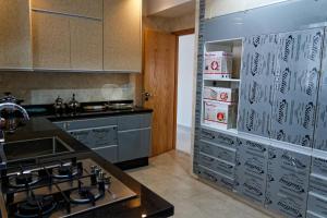 a kitchen with a stove and a counter top at Villa Luxe Dar Bouazza - Piscine Privée - Fibre 100Mb - 3 min Plage in Casablanca