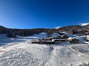 an aerial view of a ski lodge in the snow at Très beau studio rénové Puy Saint Vincent 1600 in Puy-Saint-Vincent