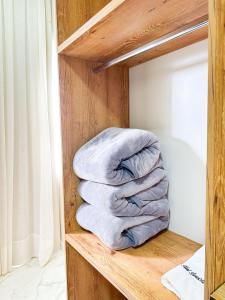 a stack of towels sitting on a shelf at Hotel Barruada in Boa Vista +63 photos