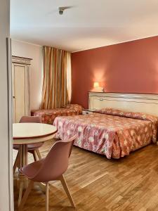 Postel nebo postele na pokoji v ubytování Hotel Matteotti