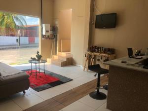 a room with a kitchen and a living room at Pousada Kactus in Piranhas